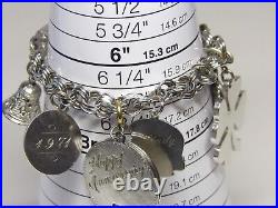 Marked JB sterling charm bracelet with safety chain with 9 charms vintage