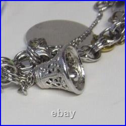 Marked JB sterling charm bracelet with safety chain with 9 charms vintage