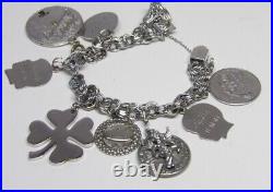 Marked JB sterling charm bracelet with safety chain with 9 charms vintage